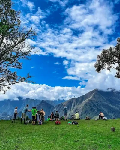 Group of beginners trekking through the scenic Salkantay Trail, with towering mountains in the background.