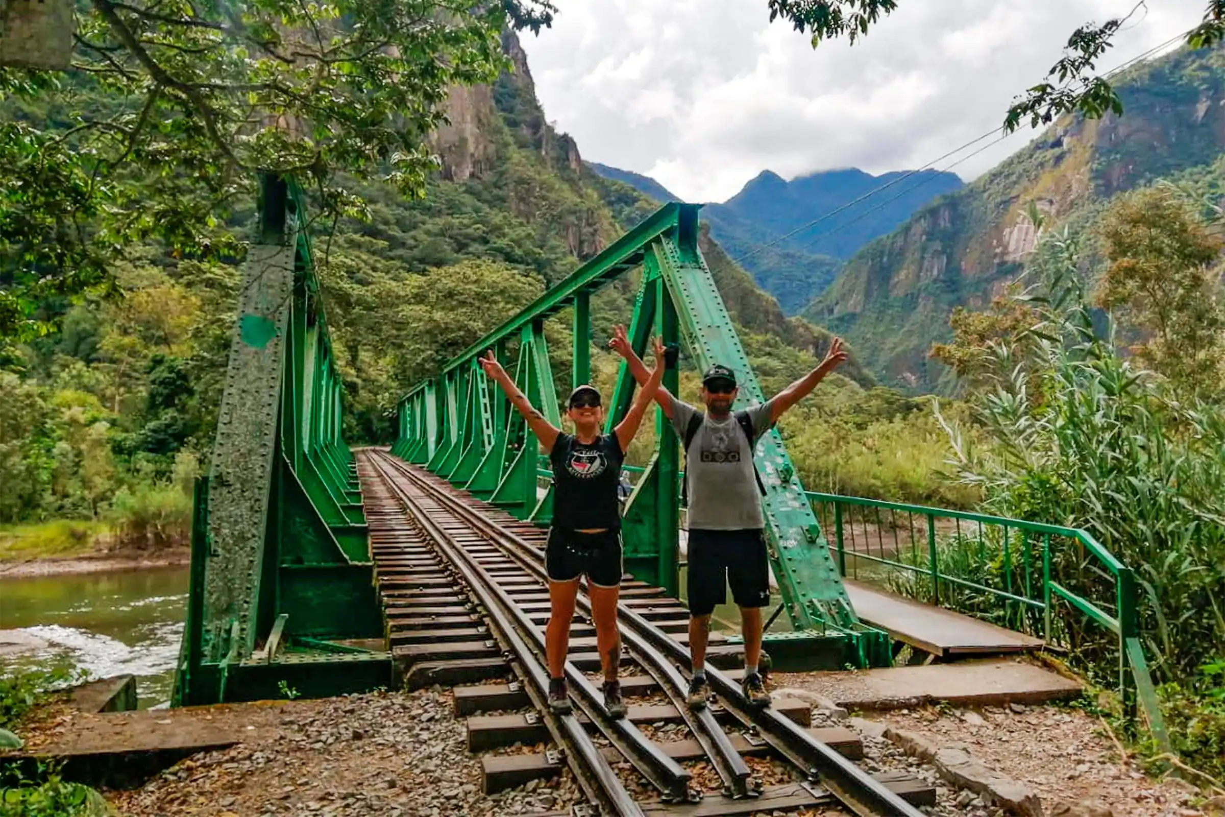 Two travelers crossing a bridge along the Hidroelectrica hike to Aguas Calientes