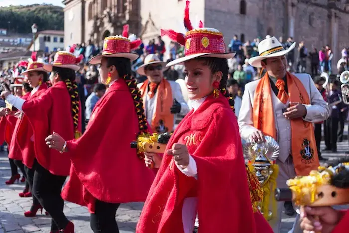 Women in colorful traditional clothing taking part in the carnivals in Peru.